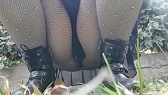 Showing Off Her Pussy In Fishnet Stockings While Peeing In Public